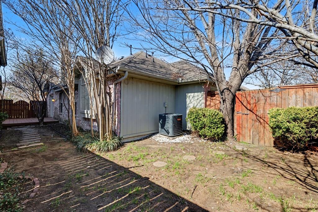 6921 Hominy Ridge Rowlett, TX 75089 - Photo 25 of 27 a view of backyard with potted plants and a large tree