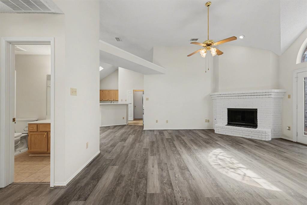 6921 Hominy Ridge Rowlett, TX 75089 - Photo 4 of 27 a view of a livingroom with wooden floor and a ceiling fan