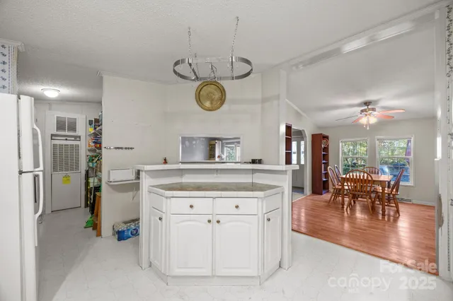 a utility room with fridge dryer and bicycles