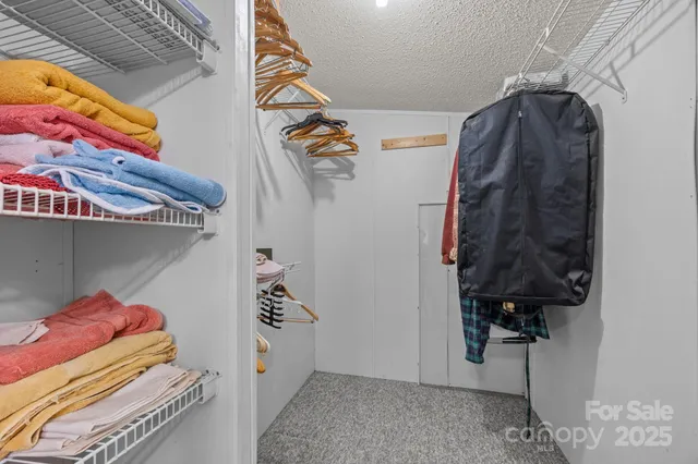 a spacious bathroom with a granite countertop sink a toilet a mirror and shower