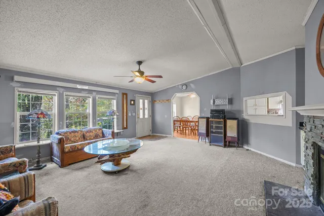 a living room with furniture a clock and a fireplace