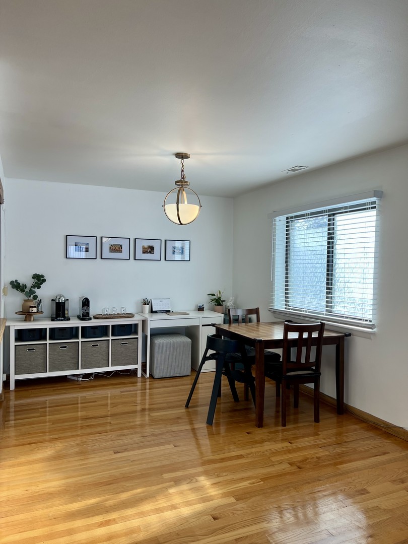 1108 Castilian Court, Unit 126 Glenview, IL 60025 - Photo 7 of 7 a view of a dining room with furniture window and wooden floor