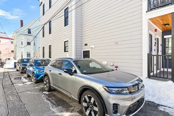 a front view of a house with parking space