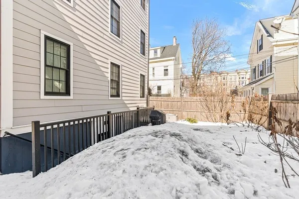 a view of a house with a wooden fence