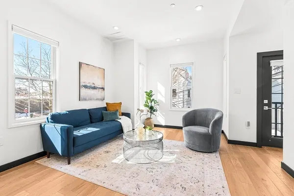 a living room with furniture rug and window