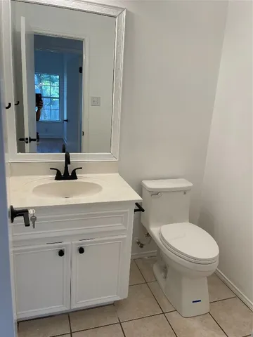 a bathroom with a sink a toilet and mirror