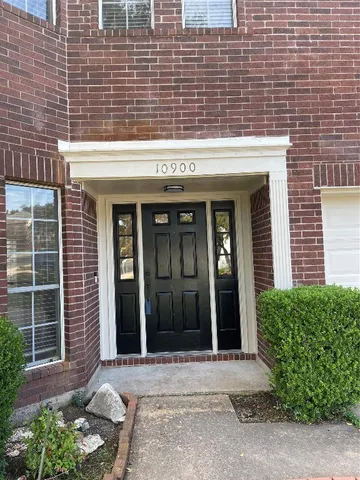 a front view of a brick house with a large windows