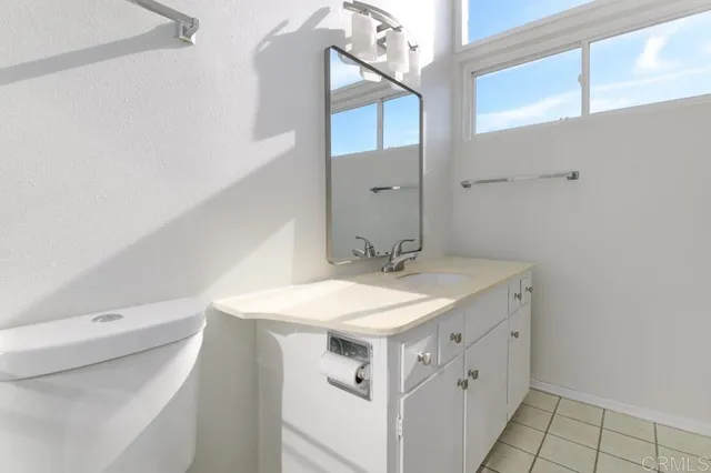 a bathroom with a sink toilet vanity and a mirror