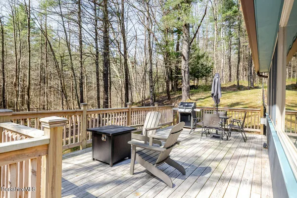 a view of a patio with table and chairs couches with wooden floor and fence