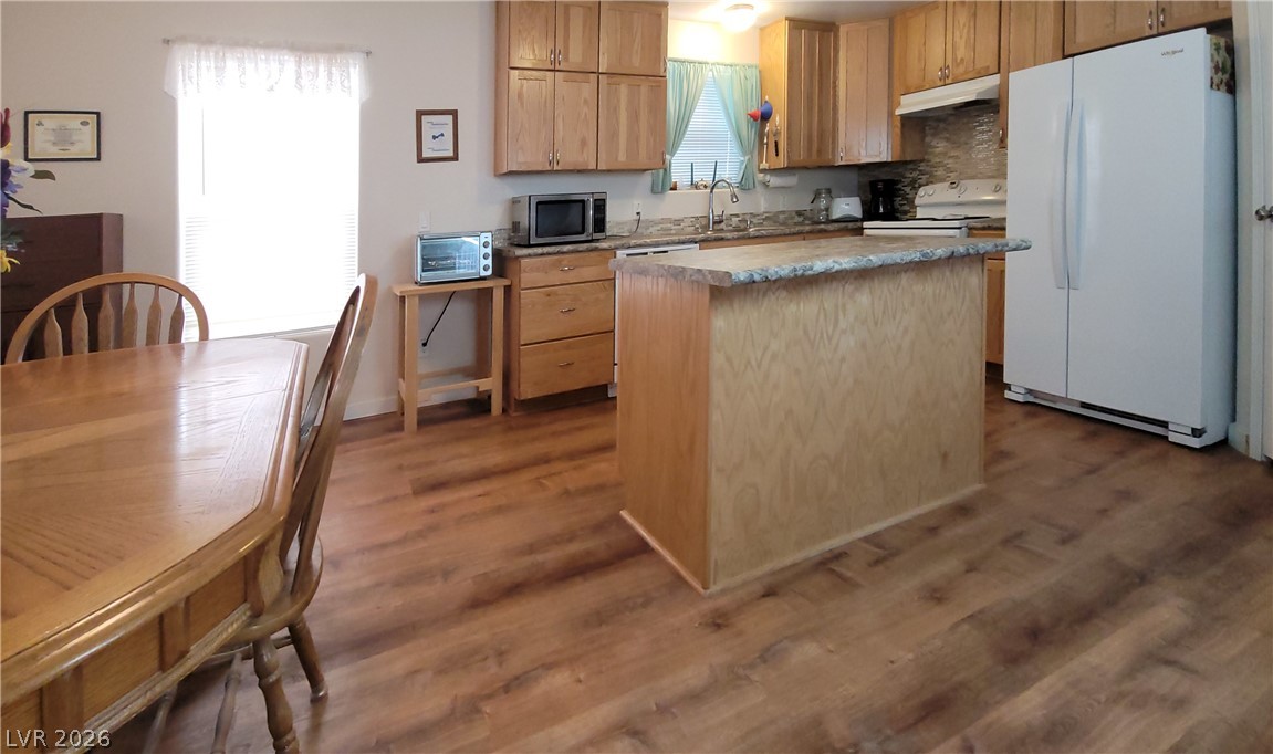 2586 South Miner Road Amargosa Valley, NV 89020 - Photo 8 of 10 A well-lit kitchen with natural wood cabinetry and a central island offers a functional culinary space.