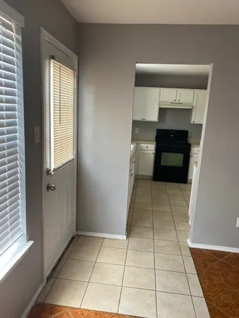 a room with a washing machine and cabinets