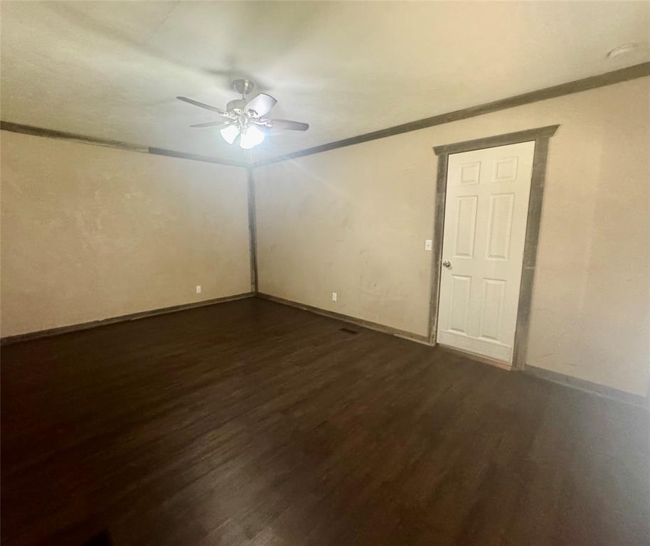 934 Tiffany Street Azle, TX 76020 - Photo 11 of 25 a view of a room with wooden floor and a ceiling fan