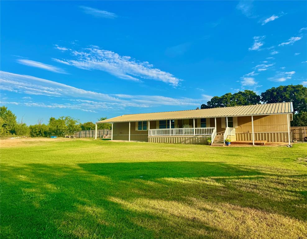 934 Tiffany Street Azle, TX 76020 - Photo 3 of 25 a front view of a house with a garden
