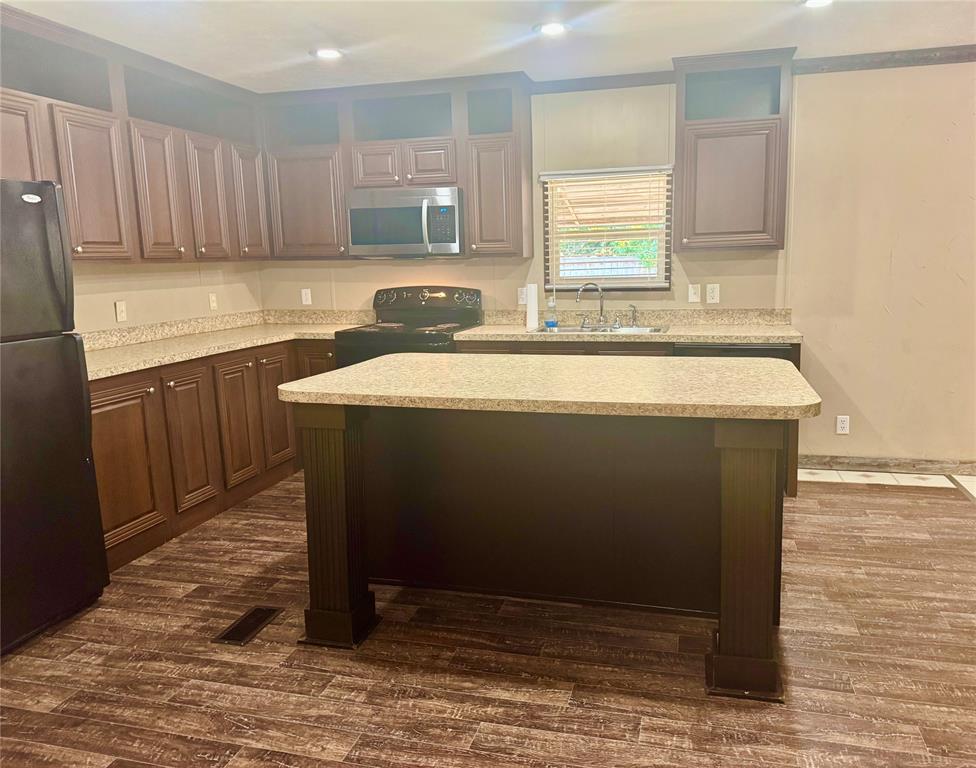 934 Tiffany Street Azle, TX 76020 - Photo 6 of 25 a room with a sink cabinets and wooden floor