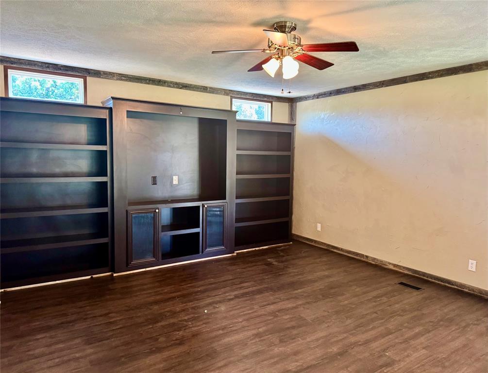 934 Tiffany Street Azle, TX 76020 - Photo 8 of 25 wooden floor in an empty room with a window