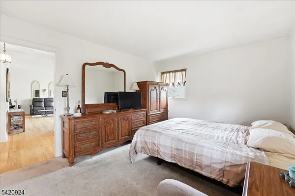 a bedroom with a bed and dresser