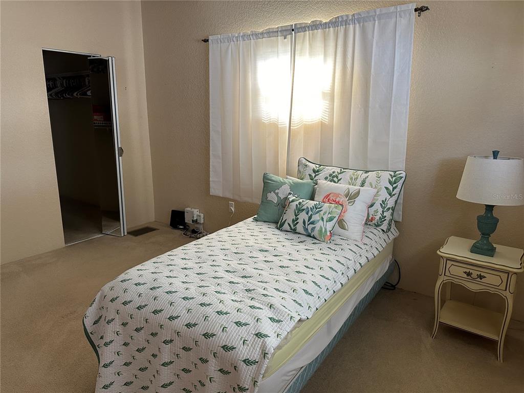 5791 Orange Blossom Road Venice, FL 34293 - Photo 11 of 24 a bedroom with a bed and a lamp