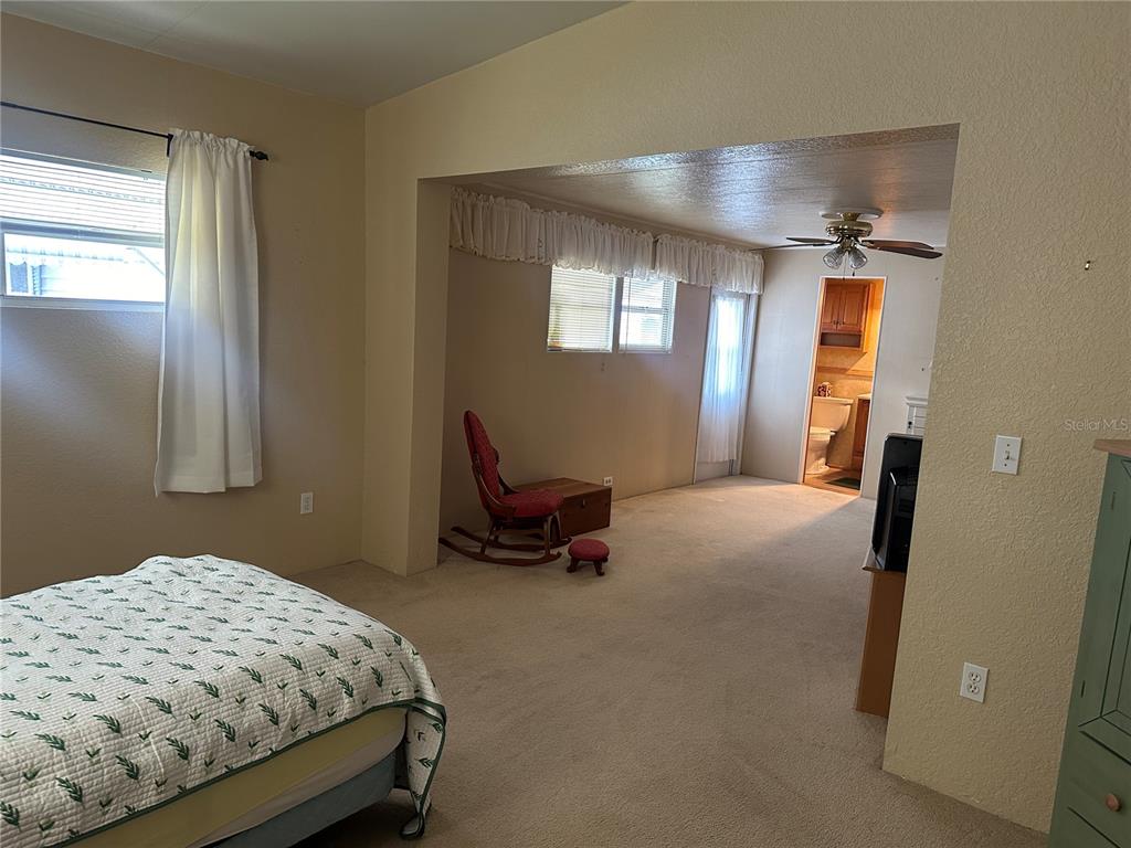 5791 Orange Blossom Road Venice, FL 34293 - Photo 12 of 24 a bedroom with a bed and wooden floor