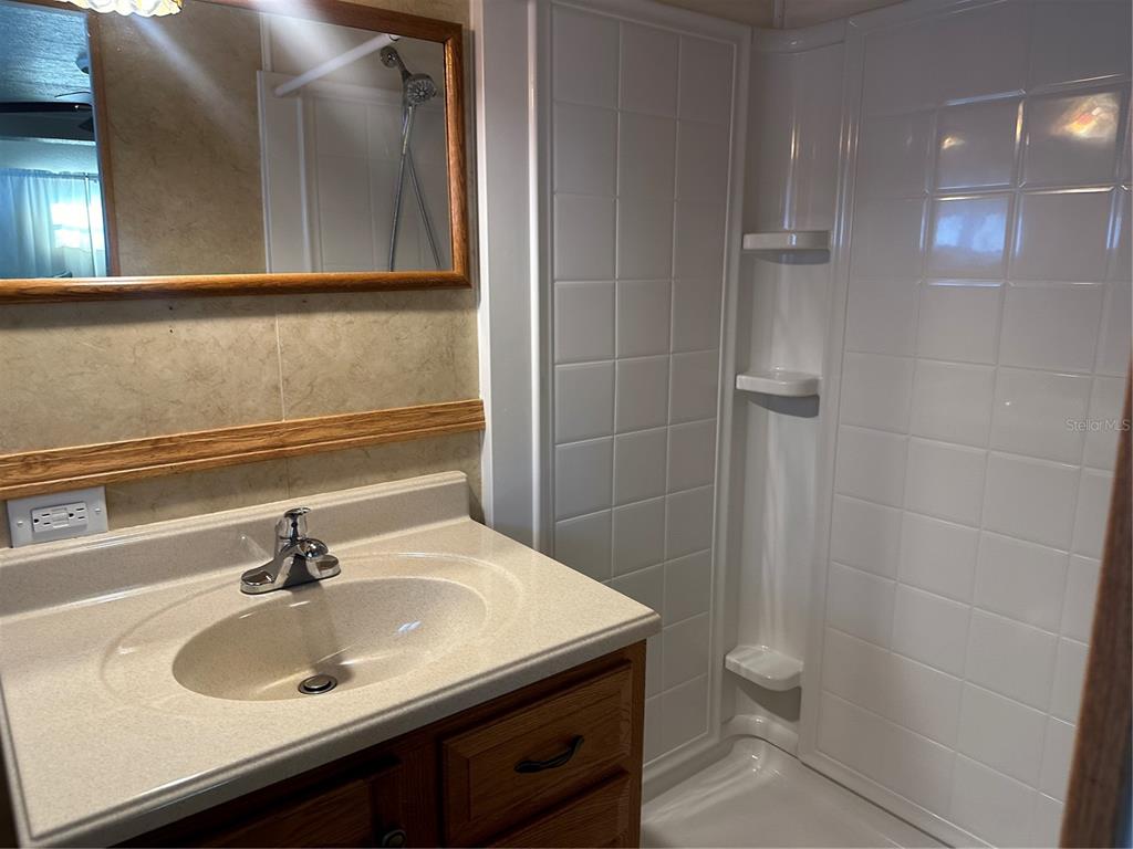 5791 Orange Blossom Road Venice, FL 34293 - Photo 13 of 24 a bathroom with a sink and a mirror