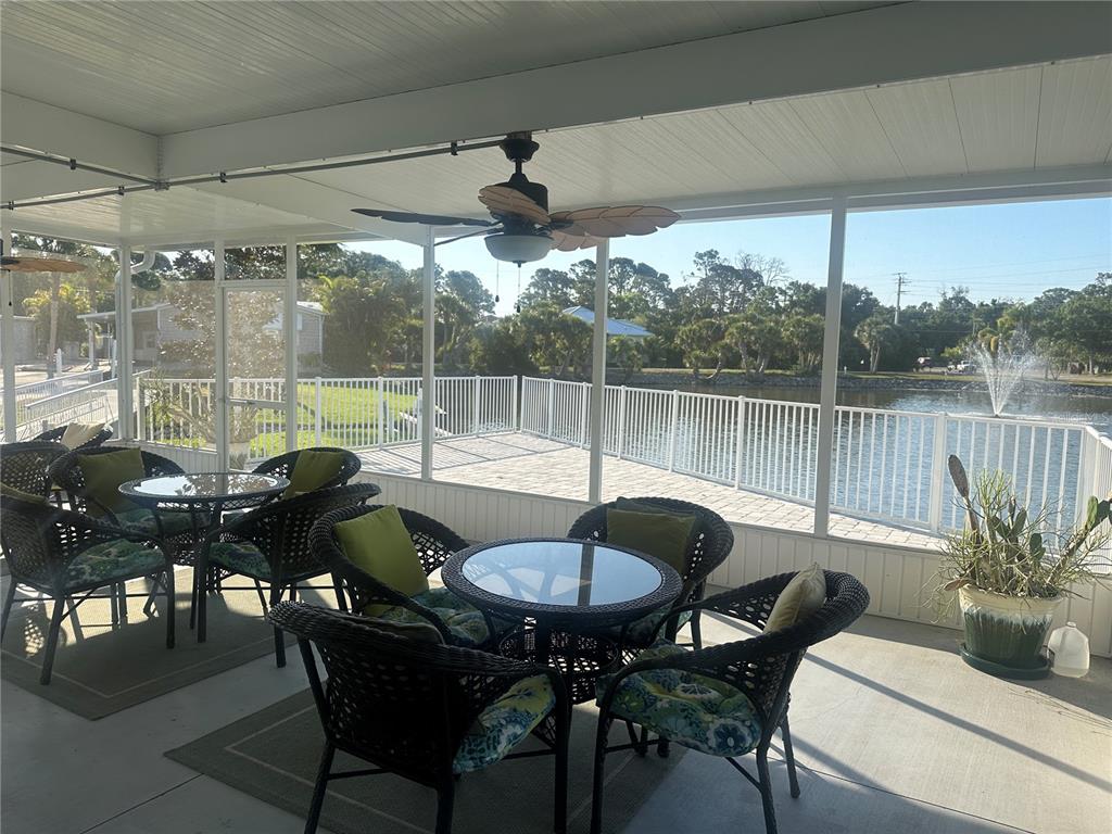 5791 Orange Blossom Road Venice, FL 34293 - Photo 20 of 24 a view of a dining table and chairs in the patio