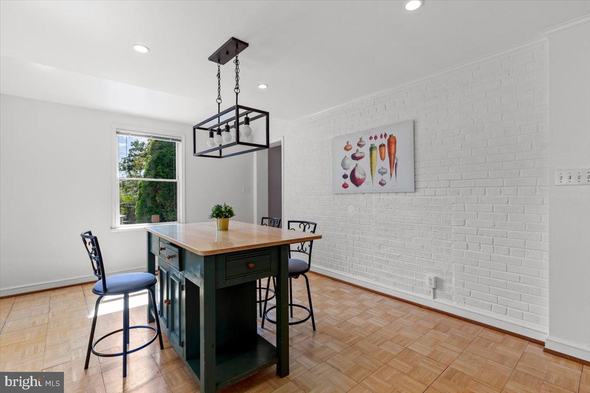 6023 Walhonding Road Bethesda, MD 20816 - Photo 17 of 37 a view of a dining room with furniture window and wooden floor