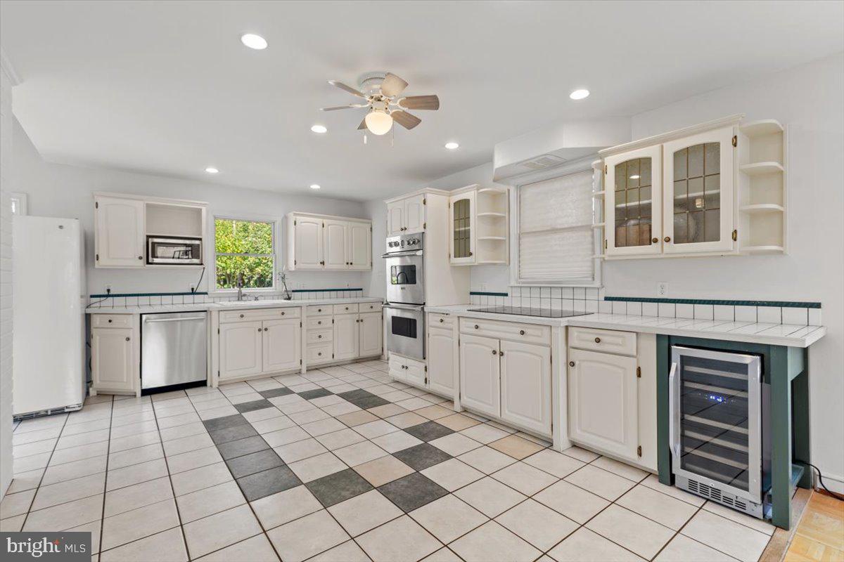 6023 Walhonding Road Bethesda, MD 20816 - Photo 18 of 37 a large white kitchen with cabinets