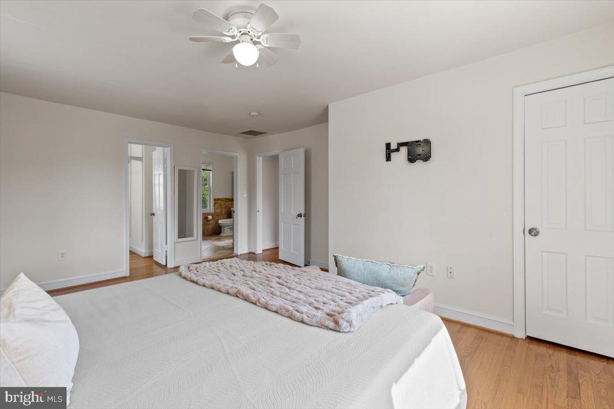 6023 Walhonding Road Bethesda, MD 20816 - Photo 21 of 37 a bedroom with a bed and wooden floor