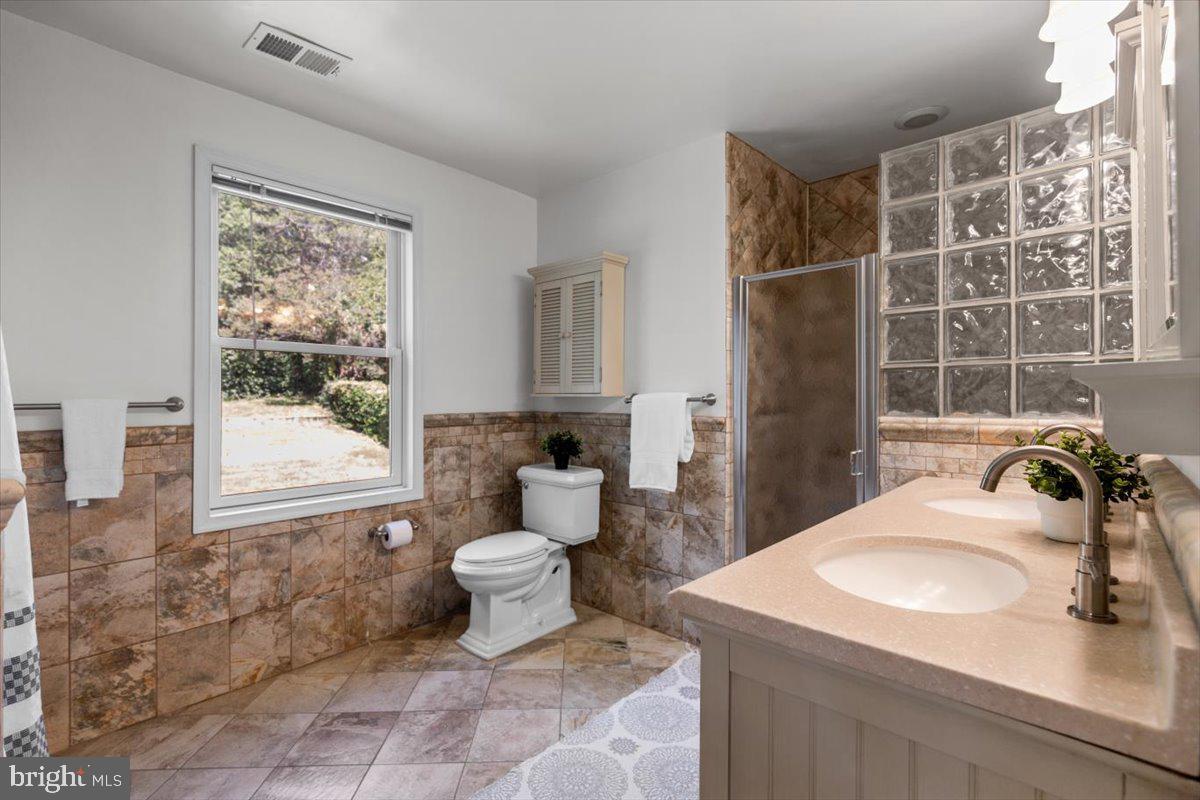6023 Walhonding Road Bethesda, MD 20816 - Photo 23 of 37 a bathroom with a sink toilet and shower