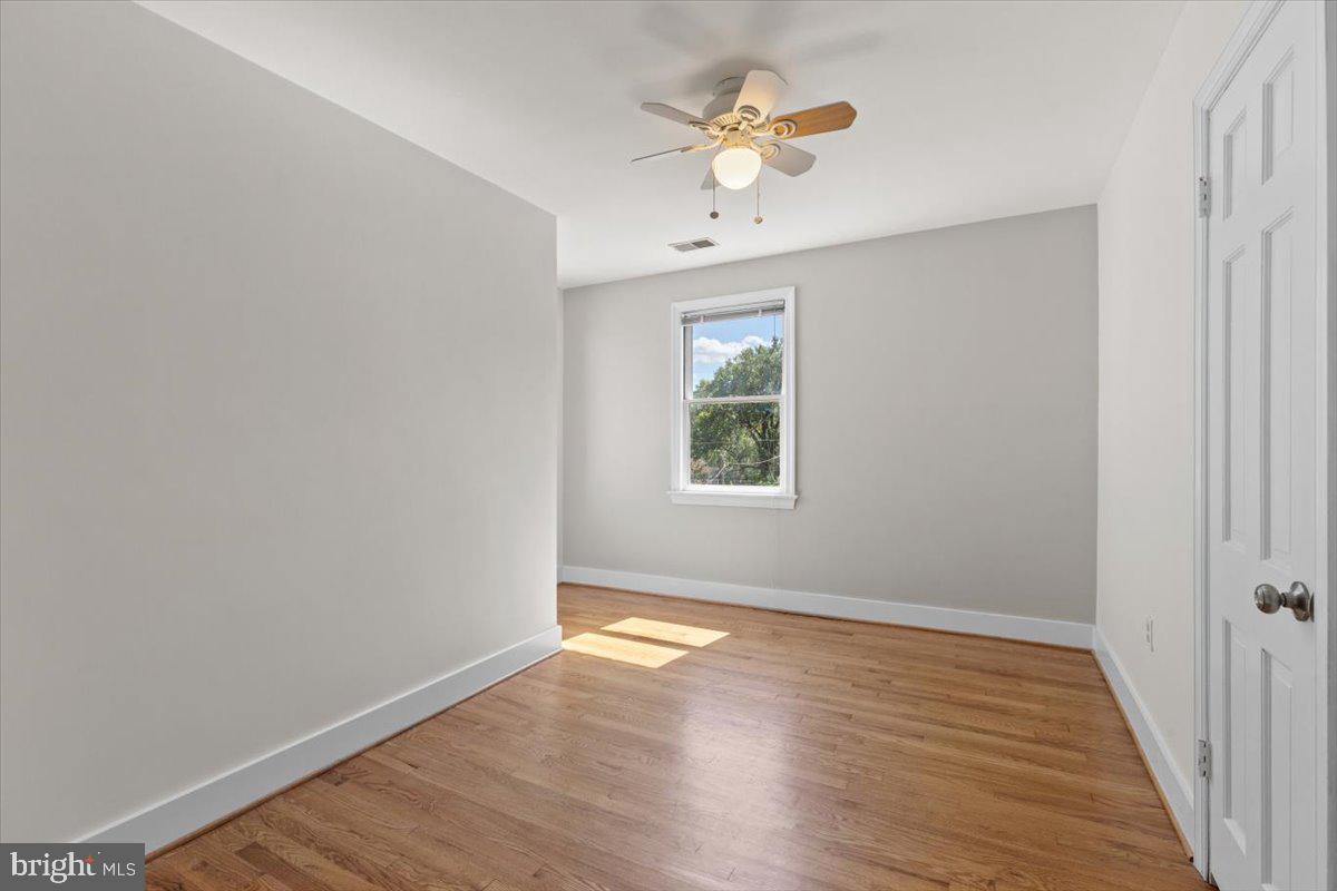 6023 Walhonding Road Bethesda, MD 20816 - Photo 24 of 37 wooden floor in an empty room with a window