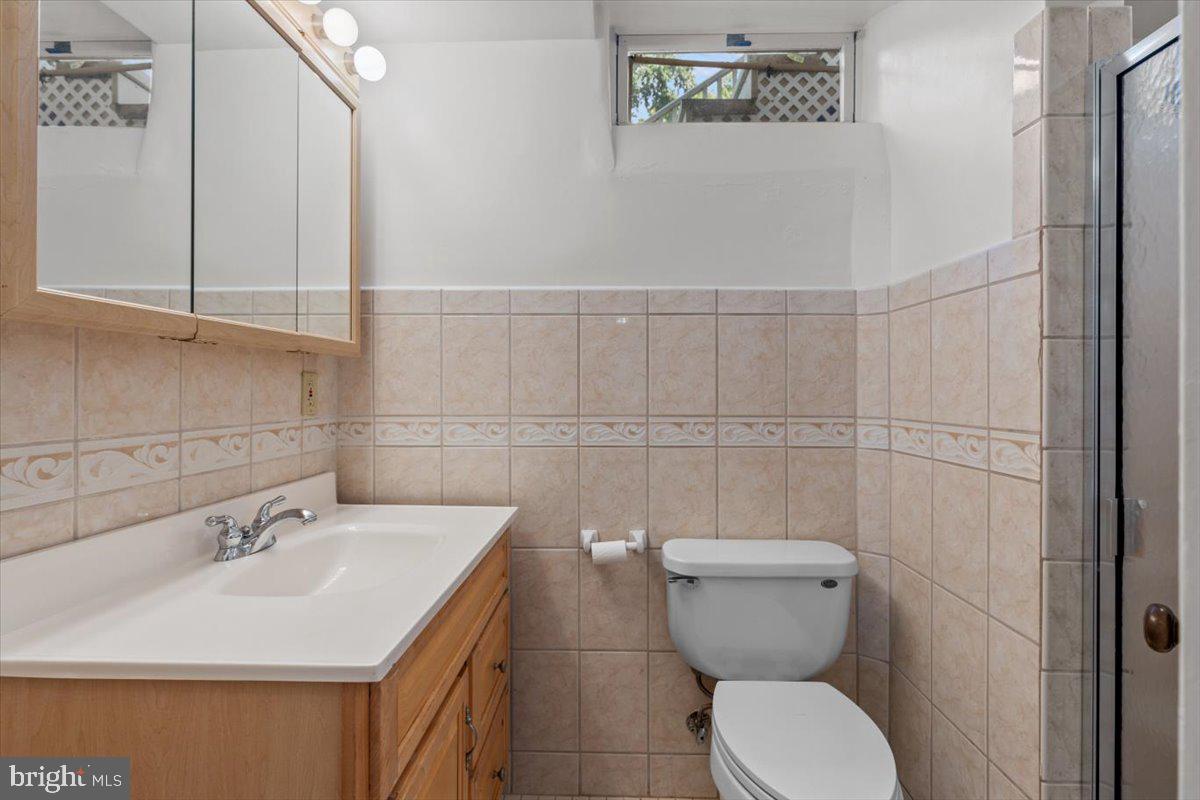 6023 Walhonding Road Bethesda, MD 20816 - Photo 30 of 37 a bathroom with a toilet sink and mirror