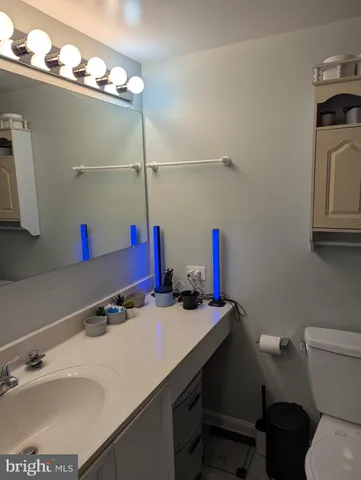 a bathroom with a sink vanity and a toilet