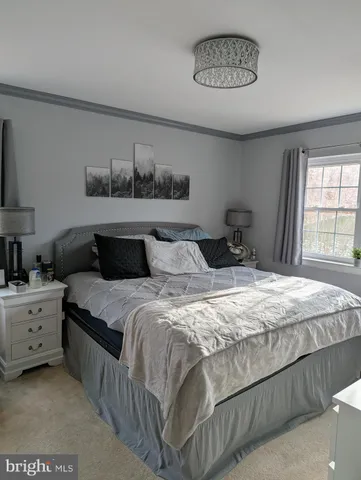 a bedroom with bed and window