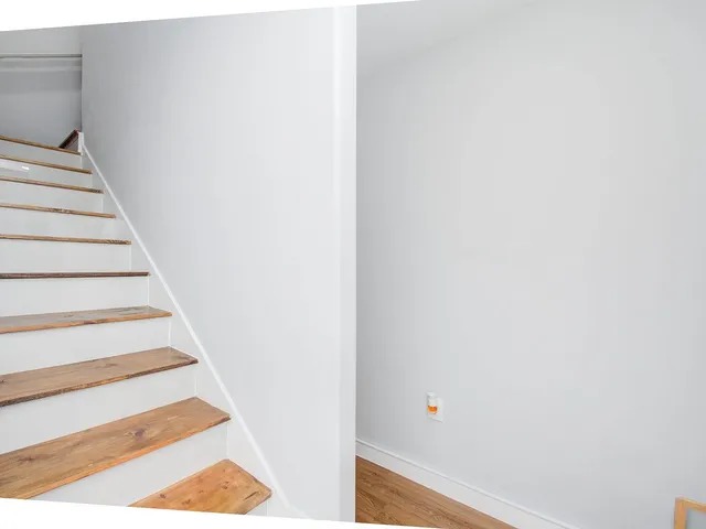 a view of staircase with white walls