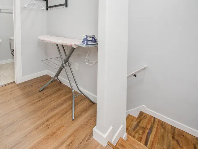 a view of a room with wooden floor and windows