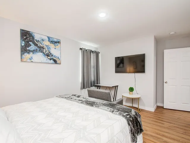 a bedroom with a bed and a flat screen tv