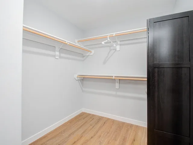 a view of a room with wooden floor