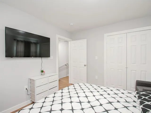 a bedroom with a bed and a chair