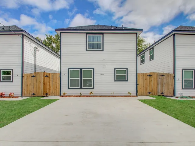 a view of a house with a yard and garage
