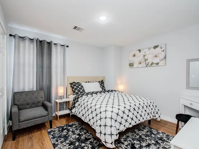 a bedroom with a bed and a couch