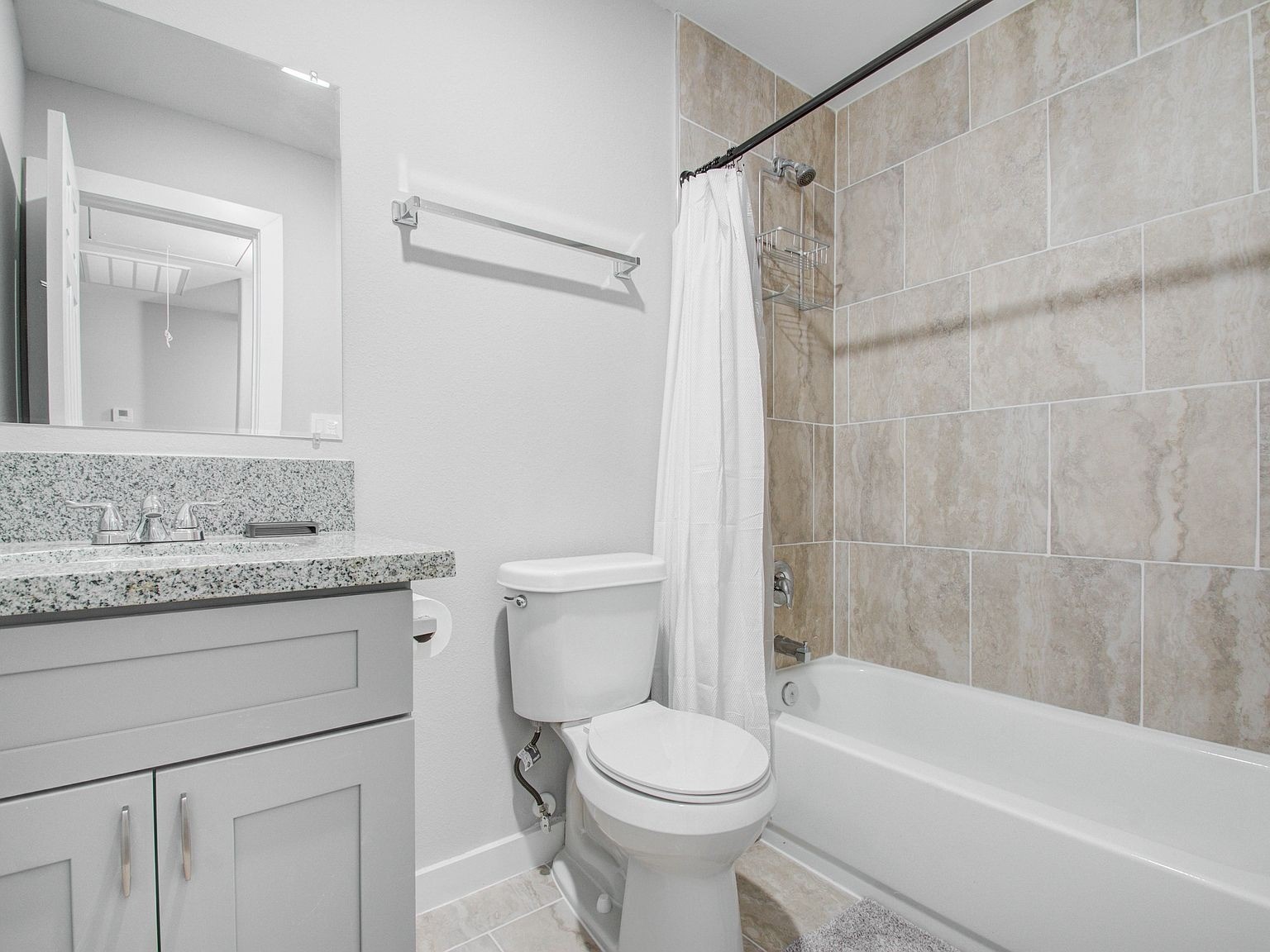 6610 Haight Street, Unit A Houston, TX 77028 - Photo 23 of 31 a bathroom with a granite countertop bathtub shower sink vanity and toilet