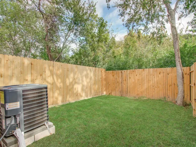a view of a backyard with wooden fence