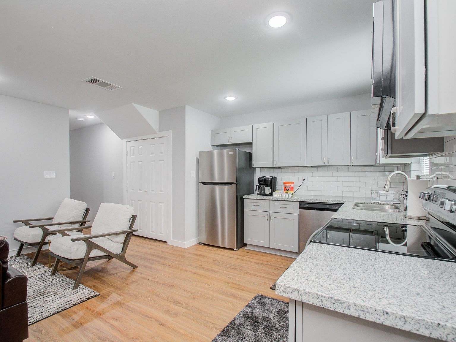 6610 Haight Street, Unit A Houston, TX 77028 - Photo 6 of 31 a kitchen with refrigerator and chairs