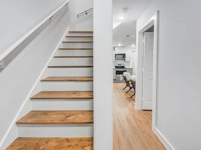 a view of entryway and hall with wooden floor