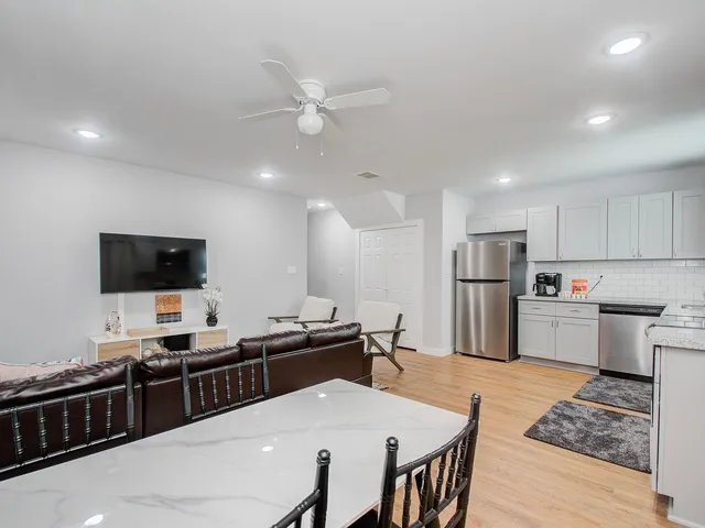 a large kitchen with a table and chairs