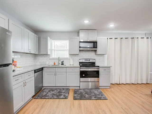 a kitchen with a sink stove and cabinets
