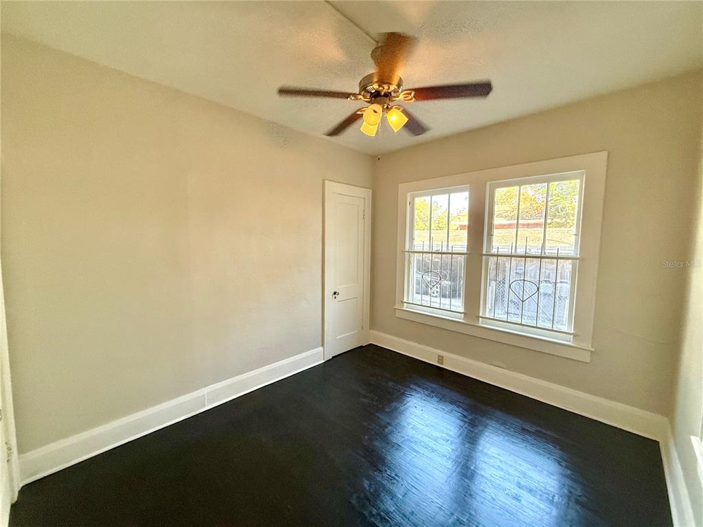 4015 North Seminole Avenue, Unit 2 Tampa, FL 33603 - Photo 11 of 17 a view of an empty room with wooden floor and a window