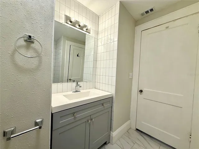 a bathroom with a sink a mirror and a shower