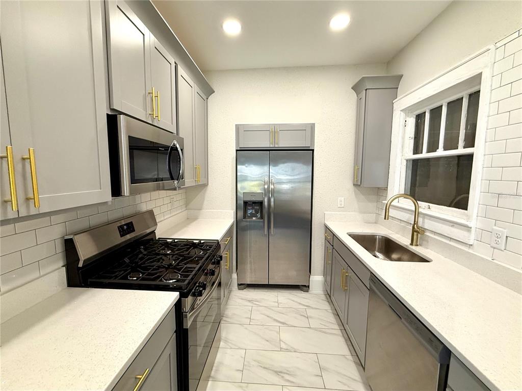 4015 North Seminole Avenue, Unit 2 Tampa, FL 33603 - Photo 7 of 17 a kitchen with a sink stove and refrigerator