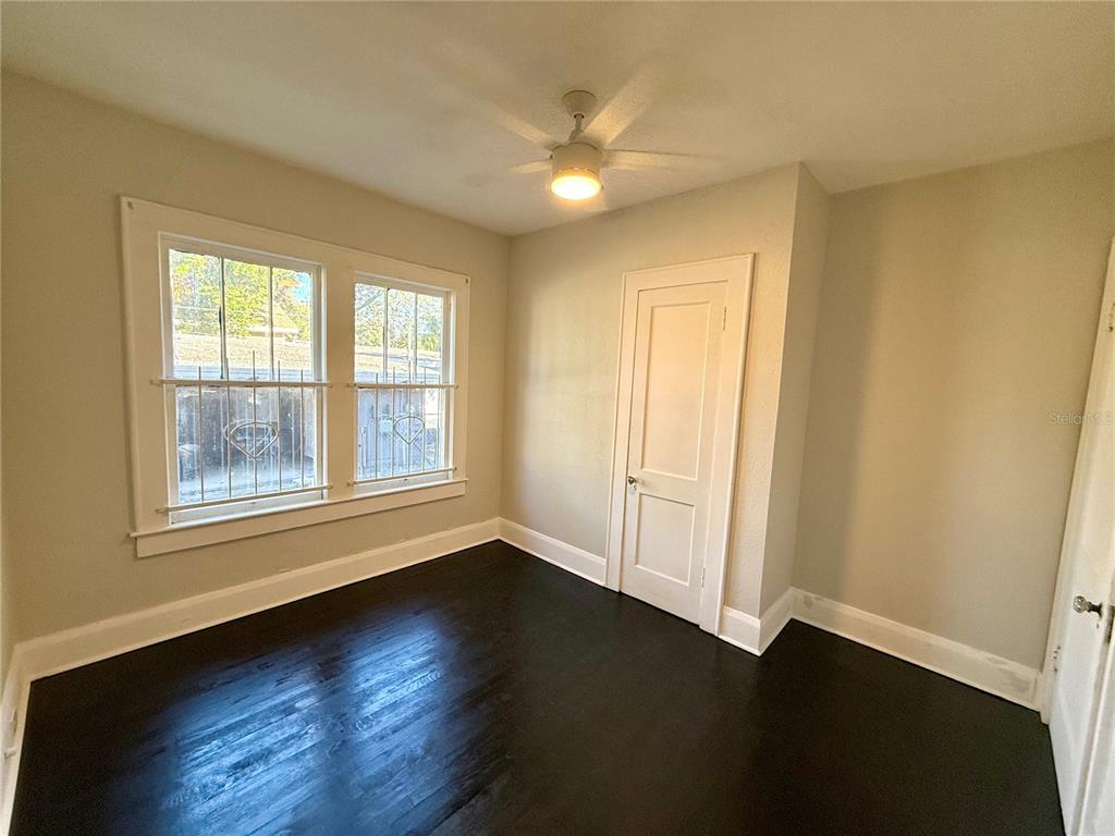 4015 North Seminole Avenue, Unit 2 Tampa, FL 33603 - Photo 9 of 17 a view of an empty room with wooden floor and a window