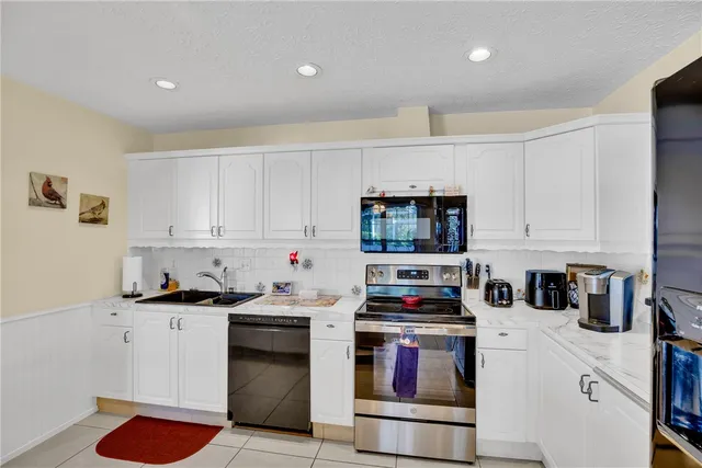 a dining room with furniture and a floor to ceiling window